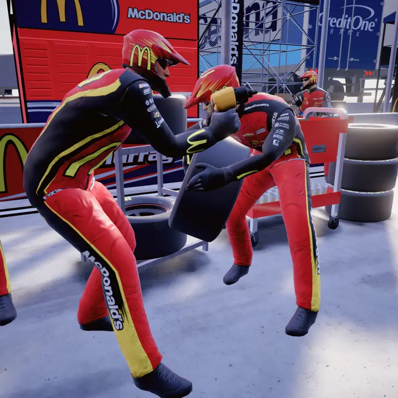 Two 3D-modeled pit crew members crouch in the ready position with wheel and bolt gun in hand